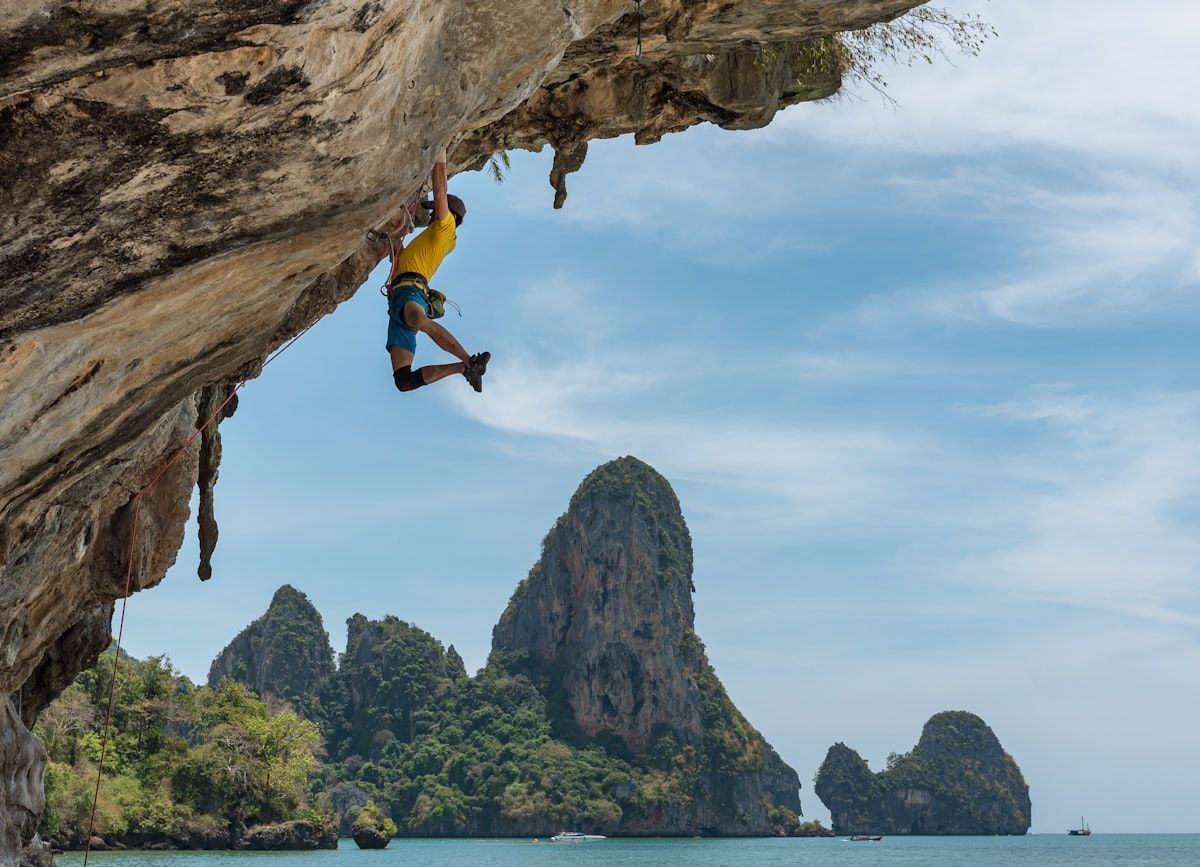 Climber ascending an overhanging rock face